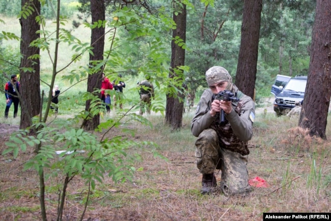 A member of the Spas-23 Battalion takes aim during an outdoor training session near Kyiv.