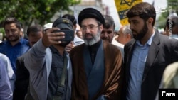 Mojtaba Khamenei (center) is the son of Ali Khamenei, Iran's supreme leader.