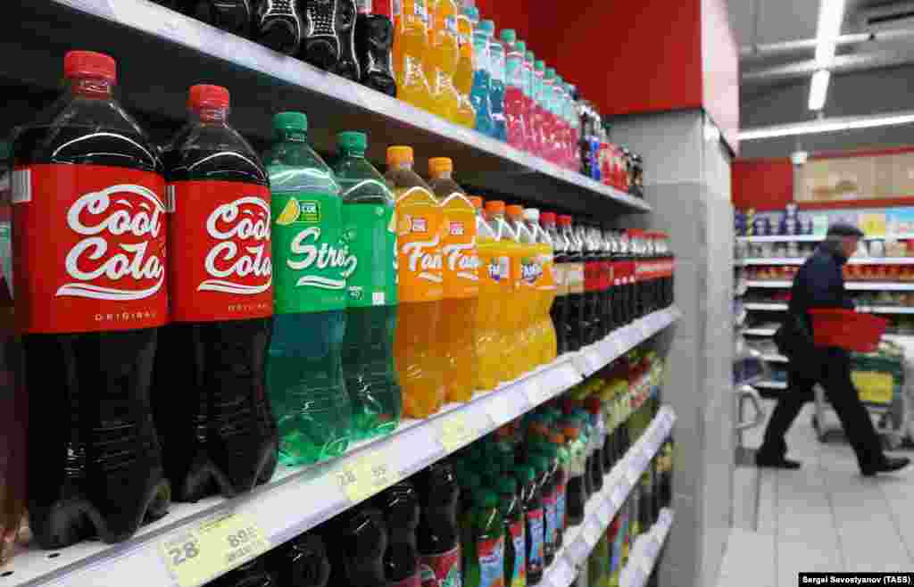 Coca-Cola stopped production and sales in Russia in August 2022, leading to a flurry of similar drinks being produced domestically to fill the gap in the local market. This photo shows Russian-made Cool Cola, Street, and Fancy drinks on sale at a grocery store in Moscow. &nbsp;