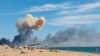 Smoke is seen from the beach at Saky after explosions were heard from the direction of the Russian military air base near Novofedorivka in Crimea in August