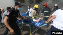 Armenia - A man is rushed to hospital after a powerful explosion at the Surmalu market in Yerevan, August 14, 2022.