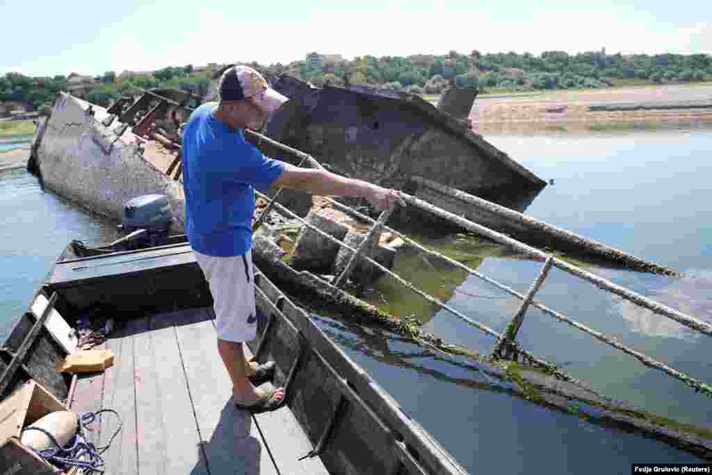 More than 20 hulks have been discovered close to Prahovo as a result of this year&#39;s drought, which scientists attribute to global warming. Tons of bombs and armaments are thought to be stored on several of the sunken WWII ships, endangering trade and fishermen like Skodric.