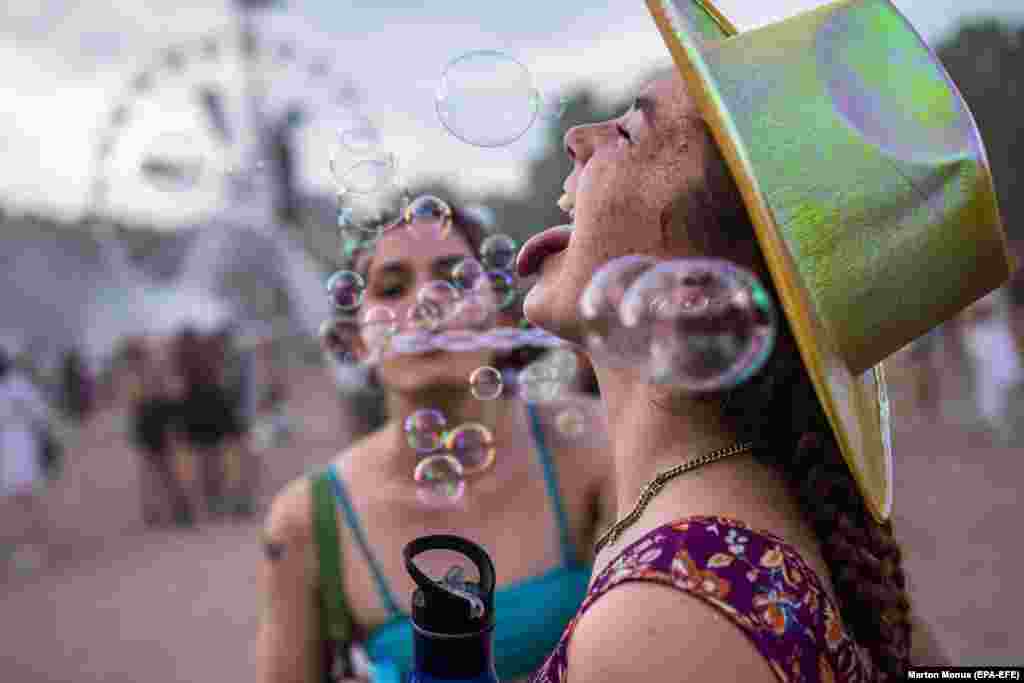 Participants blow soap bubbles at the Sziget (Island) arts festival in Budapest.&nbsp;