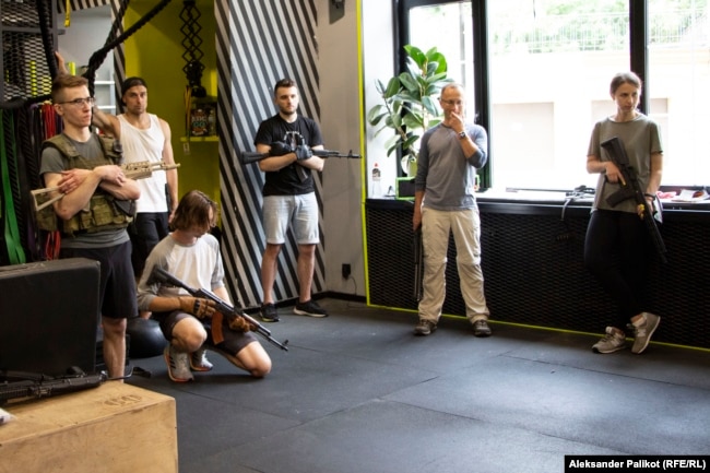 A class of tactical training for civilians organized by EBSH club convenes in Kyiv, with club co-owner Oleksandr Poloviy (second from left, in tank top and cap).