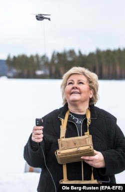 Norway's then-Prime Minister Erna Solberg flies a Black Hornet in 2019.