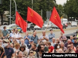 Men holding flags of the Communist Workers Party of Turkey in Gelsenkirchen on August 27.