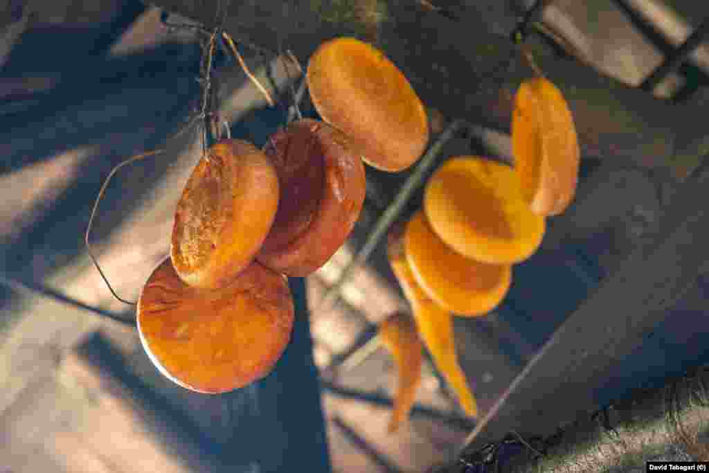 As new cheeses are made, some finished sulguni are hung from the ceiling of the hut, where they yellow above the open fire and develop a smoky tang.&nbsp;