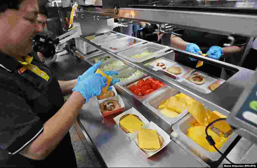 Tasty And That&rsquo;s It staff construct burgers inside a former McDonald&rsquo;s in Moscow in June 2022. The renamed fast-food chain got off to a shaky start, with one report of moldy bread being used in a burger in June, but the restaurants appear to be popular.