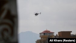 A Taliban military helicopter flies over Kabul on August 17.
