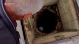 a man looks into an emty well_Kosovo