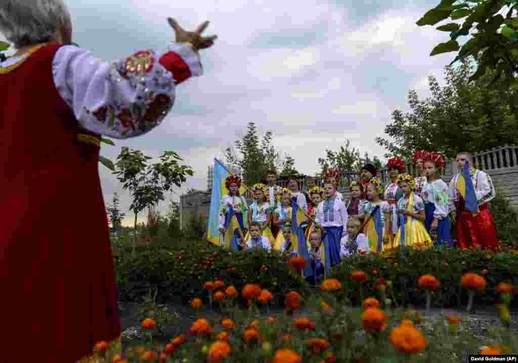 Members of a local community center wear traditional Ukrainian clothing to record an online video message for the country&#39;s upcoming Independence Day on August 24 in Andriyivka in eastern Ukraine.