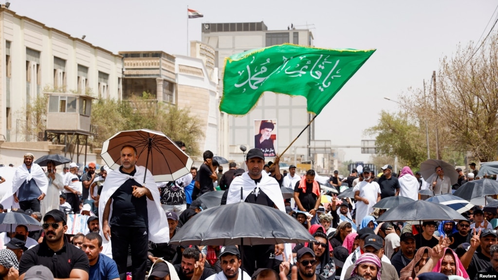 Supporters of Iraqi populist leader Muqtada al-Sadr gather for Friday Prayers in front of the parliament near the Green Zone in Baghdad on August 12.