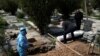 Relatives bury journalist Abdollah Zavieh, who passed away due to coronavirus disease (COVID-19), at Behesht Zahra cemetery in Tehran, March 24, 2020