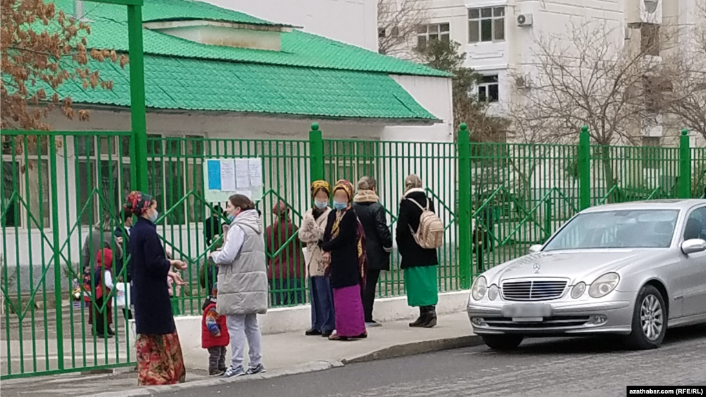 Mekdebiň öňünde çagalaryna garaşýan ene-atalar. Aşgabat. Mart 2021 