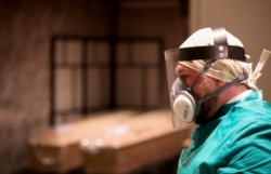 A mortuary worker wears protective gear during the coronavirus pandemic in Brussels in April.