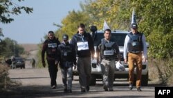 OSCE mission representatives attend the withdrawal of pro-Russia separatists from a village in eastern Ukraine earlier this month. 