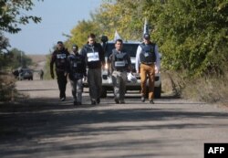 OSCE mission representatives attend the withdrawal of pro-Russia separatists from a village in eastern Ukraine earlier this month.