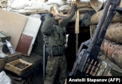 Украинский военный проверяет амуницию на позициях в районе столкновений с донбасскими сепаратистами