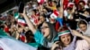 File - Iranian female football fans wave their national flags as they cheer for their national team during a screening of the Russia 2018 World Cup Group B football match between Iran and Spain in Azadi stadium in the capital Tehran, June 20, 2018