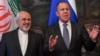 A file photo of Russian Foreign Minister Sergei Lavrov (right) with his Iranian counterpart Mohammad Javad Zarif. Moscow stands poised to capitalize on the probable withdrawal of Western companies from deals with Tehran when the U.S. reintroduces economic sanctions. 