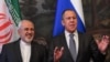 A file photo of Russian Foreign Minister Sergei Lavrov (right) with his Iranian counterpart Mohammad Javad Zarif. Moscow stands poised to capitalize on the probable withdrawal of Western companies from deals with Tehran when the U.S. reintroduces economic sanctions. 