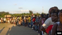 People line up to receive food at a UN distribution center last week.