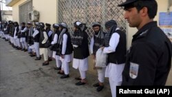 Prisoners line up at the Pul-e Charkhi prison after their release in Kabul on January 11.