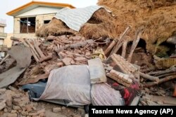 A car lays smashed by debris from an earthquake in Varankesh village in Eastern Azerbaijan province, some 250 miles (400 kilometers) northwest of the capital Tehran, November 8, 2019