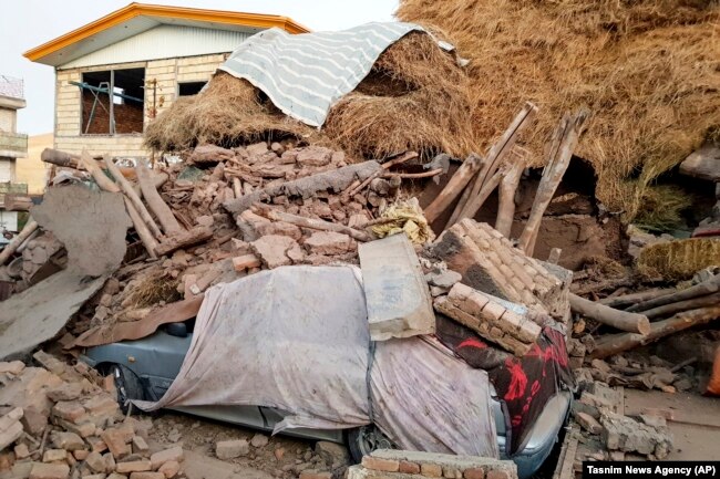 A car lays smashed by debris from an earthquake in Varankesh village in Eastern Azerbaijan province, some 250 miles (400 kilometers) northwest of the capital Tehran, November 8, 2019