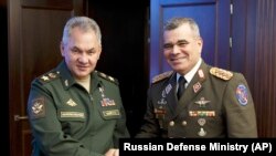 RUSSIA -- Russian Defense Minister Sergei Shoigu, left, and Venezuelan Minister of Defense Vladimir Padrino Lopez pose for a photo prior to their talks in Moscow, August 15, 201