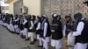 Prisoners line up at the Pul-e Charkhi prison after their release in Kabul on January 11.