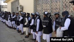 Prisoners line up at the Pul-e Charkhi prison after their release in Kabul on January 11.