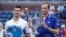 Novak Djokovic of Serbia (left) and Daniil Medvedev of Russia celebrate with the finalist and championship trophies, respectively, after their match in the men's singles final of the U.S. Open on Sept. 12 in New York.