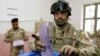 Iraqi Police, Soldiers Go To Polls Early
