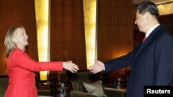 A photo of Chinese Vice President Xi Jinping meeting with U.S. Secretary of State Hillary Clinton in Beijing in May. Xi's sudden cancellation of more recent meetings set the rumor mill spinning.