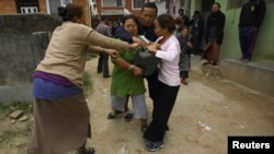 A Tibetan woman is stopped by her friends as she tries to self immolate herself after an argument with police personnel during a protest in Kathmandu in November 2011.