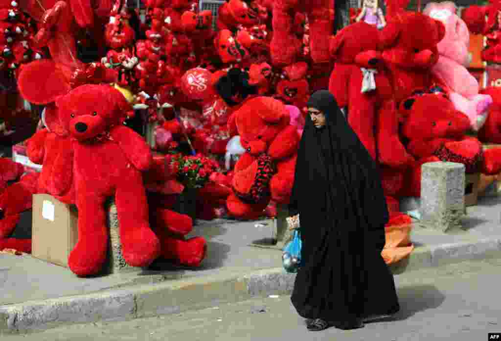 An Iraqi woman walks past a shop displaying teddy bears in preparation for Valentine's Day in Baghdad's Karrada district. (AFP/Ahmad al-Rubaye)