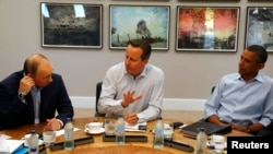 Russian President Vladimir Putin (left), British Prime Minister David Cameron (center), and U.S. President Barack Obama attend a working session at the Lough Erne golf resort where the G8 summit took place in Enniskillen, Northern Ireland, on June 18.