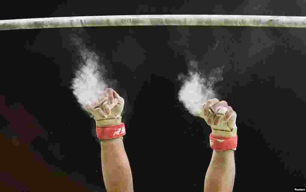 Japanese gymnast Kohei Uchimura loses his grip as he competes on the horizontal bar.&nbsp;