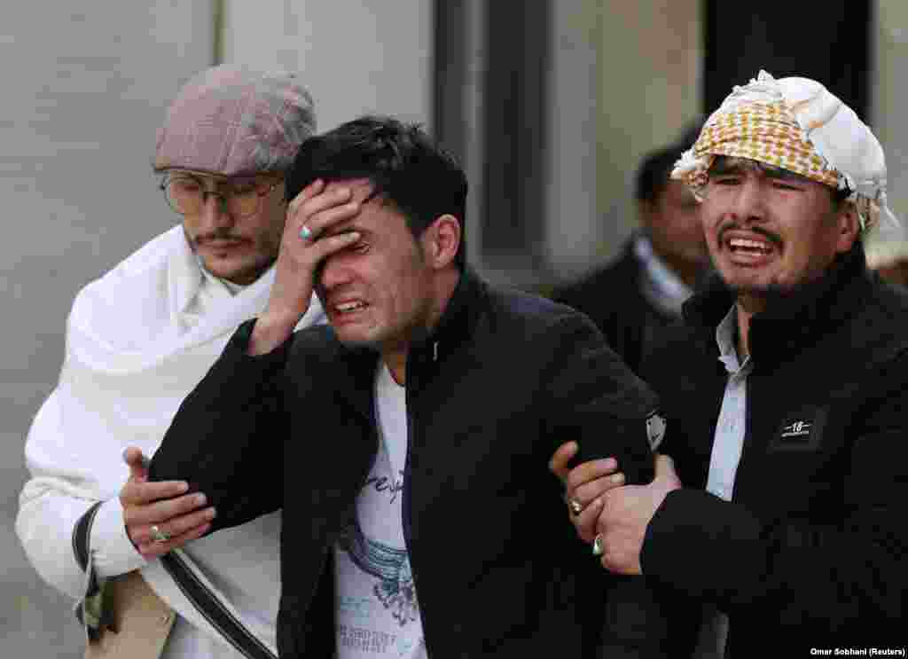 Afghan men cry at a hospital after they heard that their relative was killed during an attack in Kabul on March 6. (Reuters/Omar Sobhani)