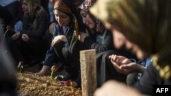 People mourn near the coffin of a victim killed in bombing attacks in Ankara on October 10.