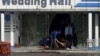 Afghan workers clean the area outside of a wedding hall on November 21 a day after a deadly suicide attack in Kabul.