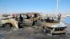 People gather at the site of a car-bomb attack in the town of Tuz Khurmatu, north of Baghdad, on May 5.