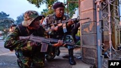 Kenyan soldiers take cover after exchangning heavy gunfire with Islamist extremists during a siege at the Westgate mall in Nairobi on September 23.