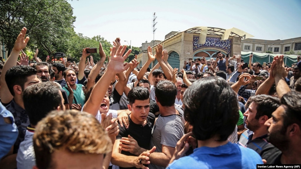 IRAN -- A group of protesters chant slogans at the main gate of old grand bazaar in Tehran, Iran, Monday, June 25, 2018. Protesters in the Iranian capital swarmed its historic Grand Bazaar on Monday, news agencies reported, and forced shopkeepers to close