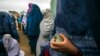 Afghan women wait in line to cast their ballots at a polling station in Mazar-e Sharif on April 5. Voting began in Afghanistan&#39;s presidential election, which will mark the first democratic transfer of power since the country. (Reuters/Zohra Bensemra)