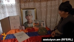 Armenia - The mother of Kyaram Sloyan, an Armenian soldier killed and decapitated in Nagorno-Karabakh, looks at his photogaphs, 10Apr2016.