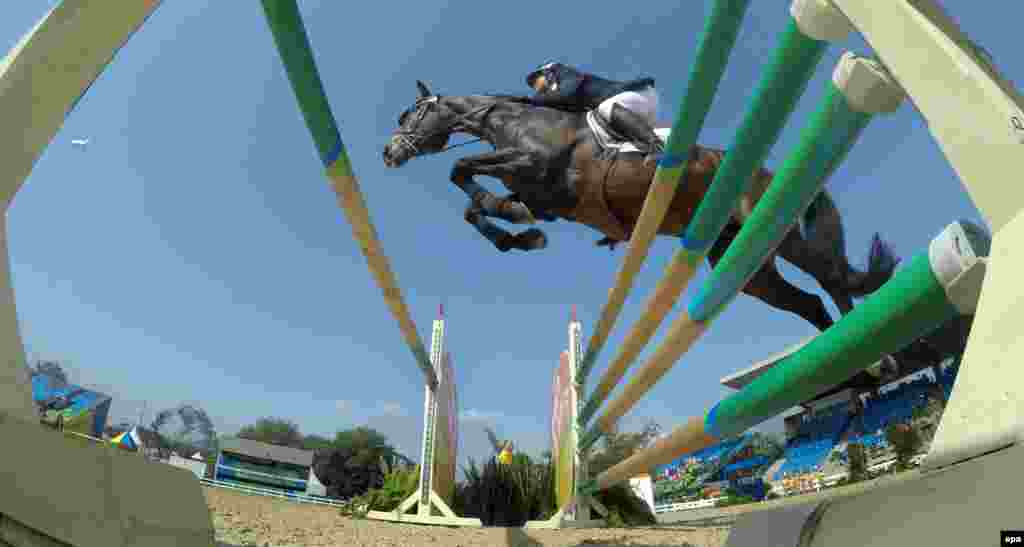 An unidentified French rider and horse sail over a jump during the eventing finals.