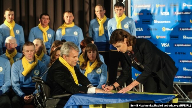 Марина Порошенко підписує паралімпійцям державний прапор України