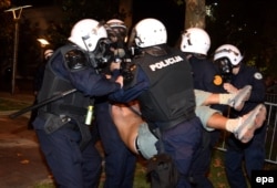 Police remove a protester from one of the demonstrations, which have occasionally been marred by violence.